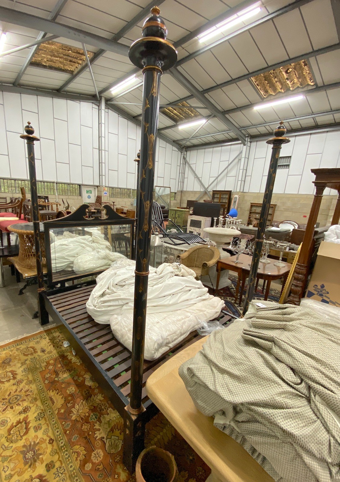 A reproduction black painted four poster bed frame with mirrored headboard, width 170cm, length 210cm, height 250cm